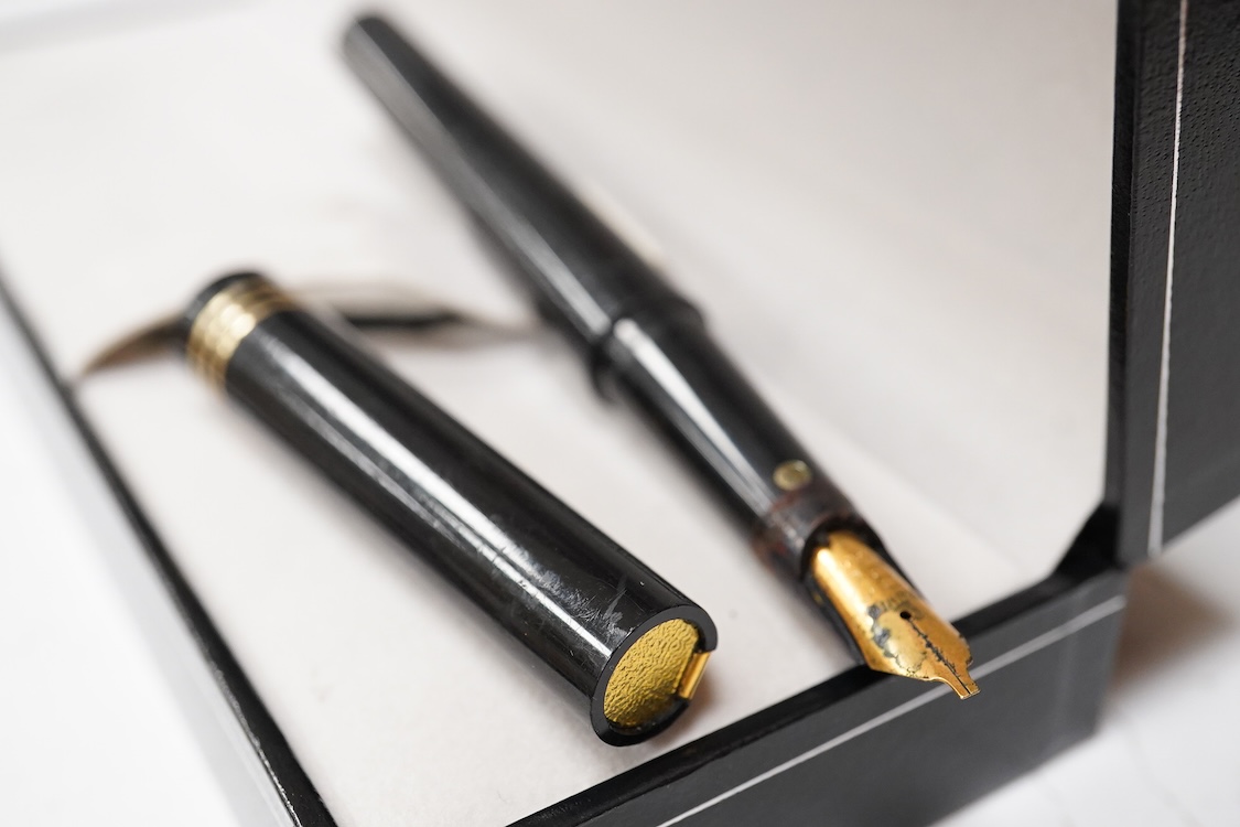 A group of five fountain pens and ballpoint pens